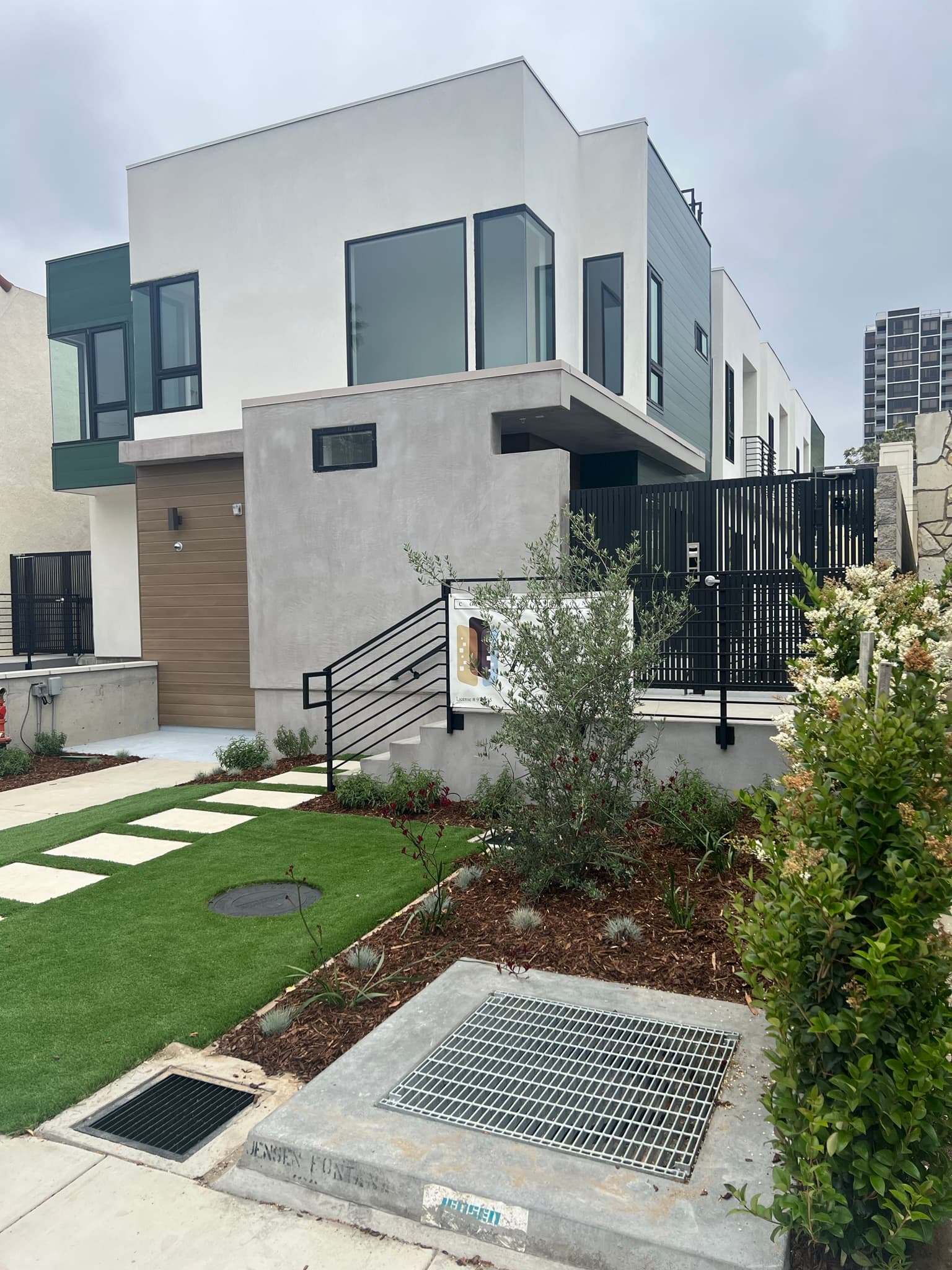 Doran Townhomes entrance with wood-clad door and courtyard gate